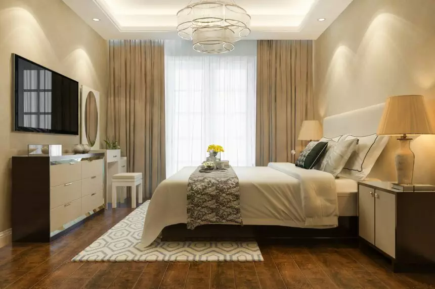luxury bedroom suite in hotel with tv and chandelier in hotel
