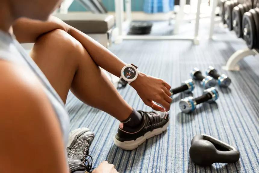 Using a smart watch while working out at the gym; health and fitness